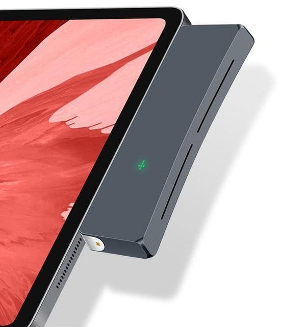 Shell Slim attached to an iPad. Cross-shaped green indicator light. Flattened U-Shape edge. Silver detailing in inner site of enclosure